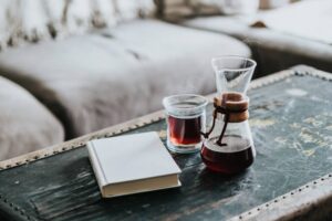 A Chemex of coffee and a book at home