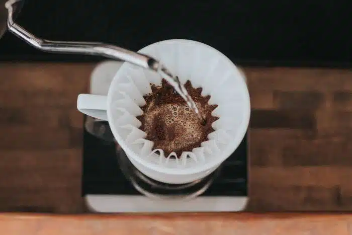 Water pouring into some blooming coffee