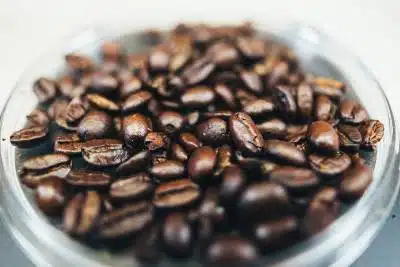 a close up of coffee beans in a jar