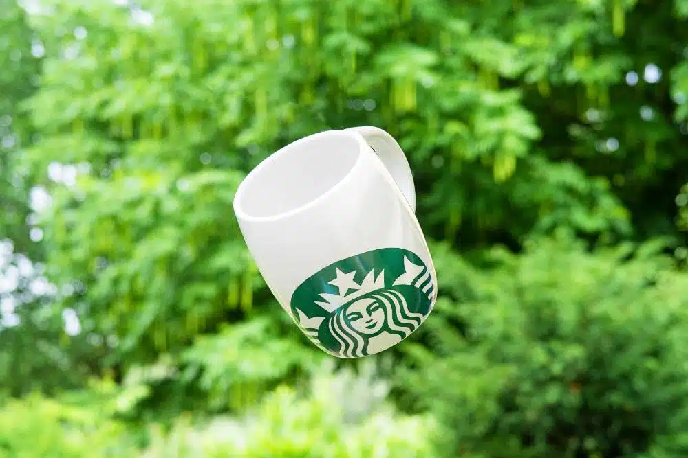 A starbucks mug in mid-air
