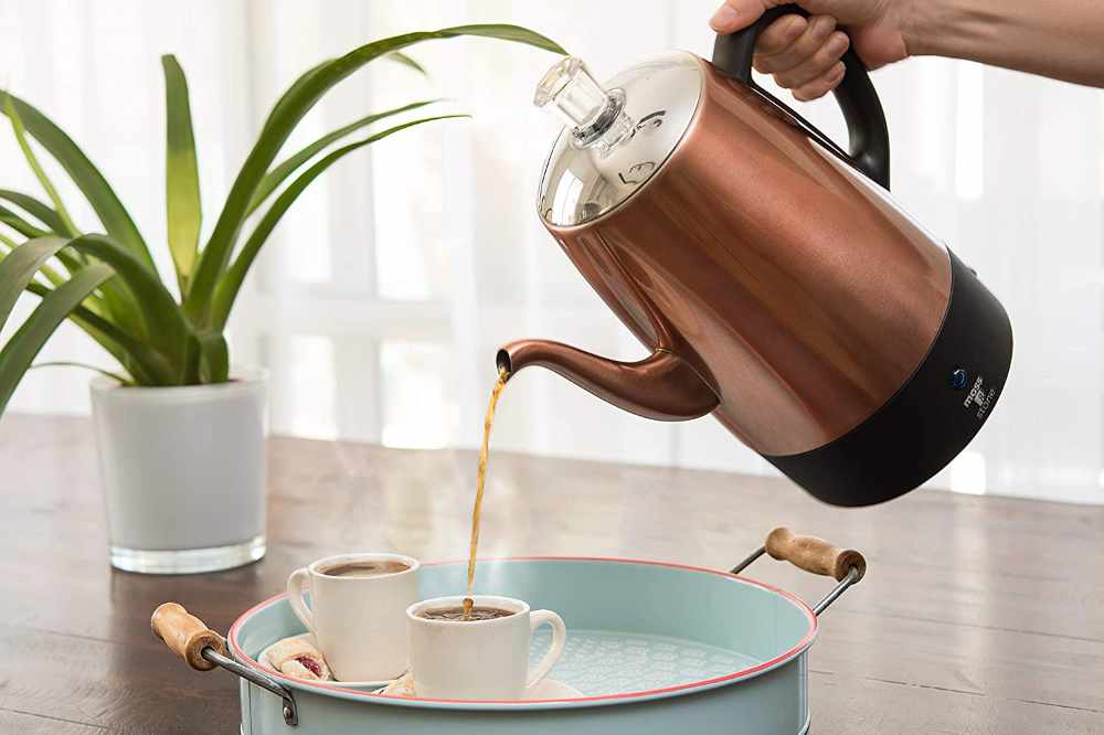 An Electric Percolator Pot Pouring Some Cups of Coffee