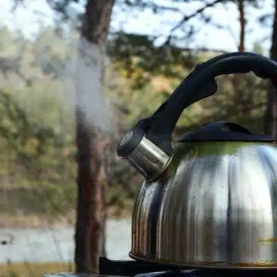 A kettle boiling on a gas stove
