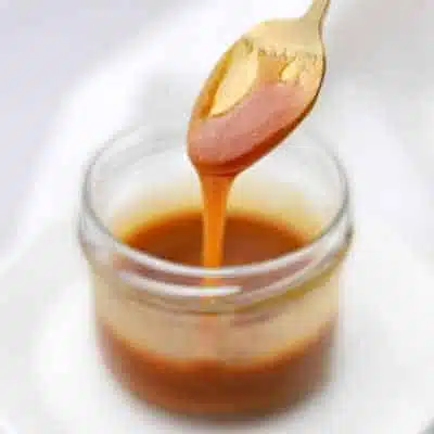 caramel syrup dripping from a spoon