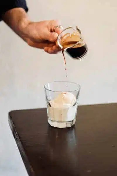pouring coffee over vanilla ice cream