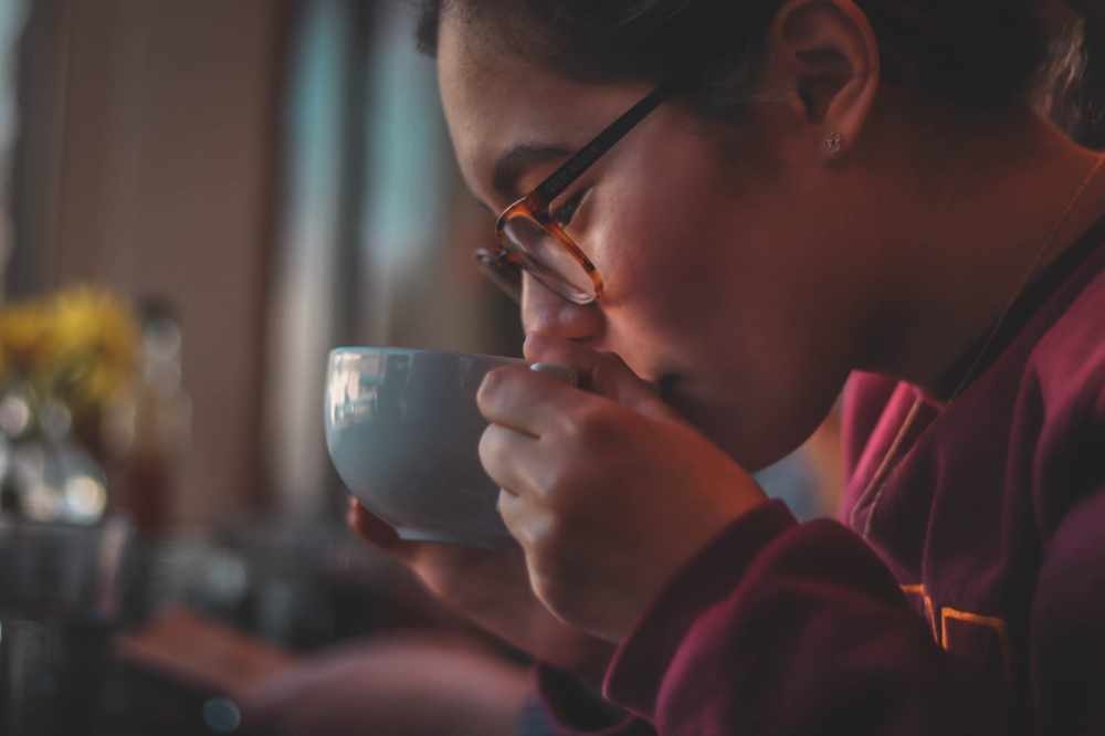 A Woman Sipping A Lovely Cup of Coffee