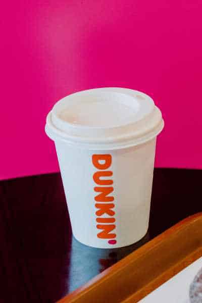 A dunkin donuts cup on a table