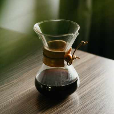 A chemex full of coffee sitting on a table