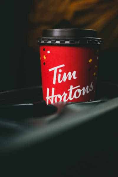 A tim hortons cup in a cupholder