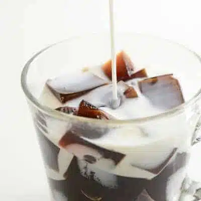 Coffee jelly with milk being poured over it
