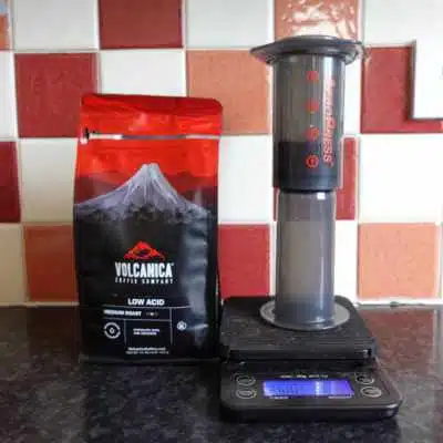 An AeroPress beside a bag of Volcanica coffee