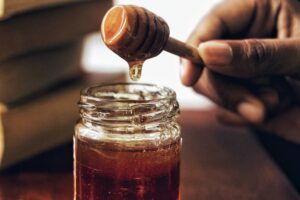 Honey drizzled into a jar